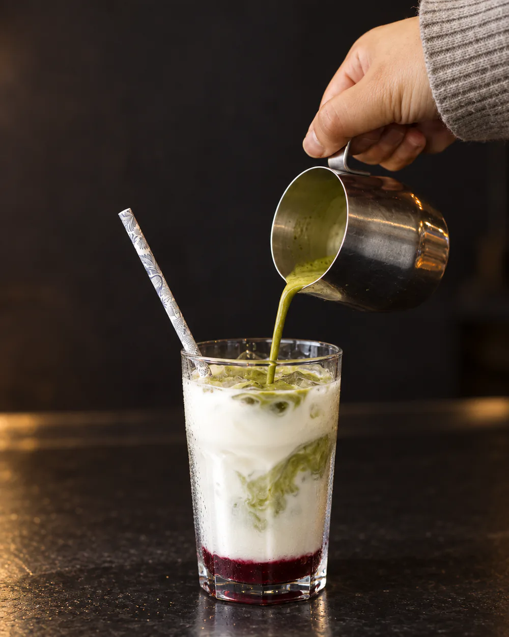 An iced green drink being poured at The Sugar Bowl Cafe